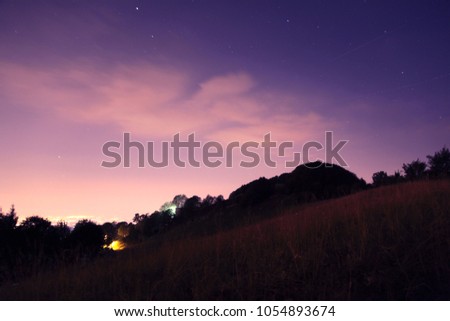 meadow at night with shooting stars