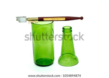 The glass cutter and the green bottle were cut off. on white background