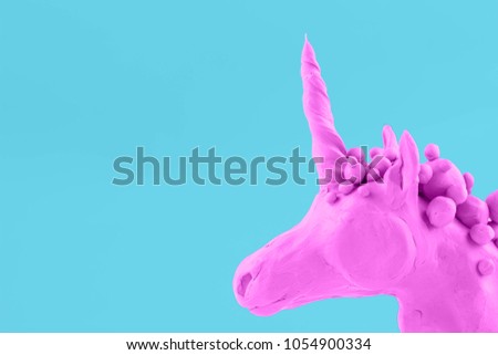 pinc unicorn on a blue background plasticine
