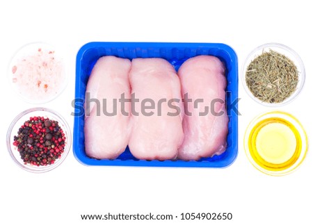 Raw chicken fillet in tray on white background. Studio Photo