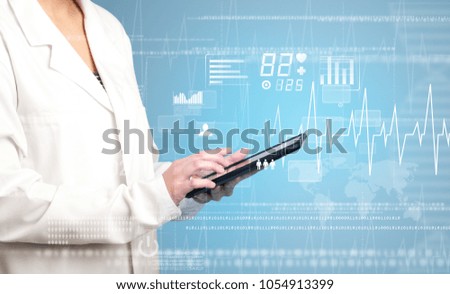 Female doctor holding tablet with blue background and heart related charts 