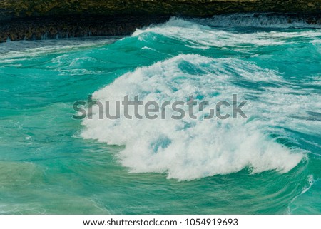 waves on the Atlantic ocean in the rocky coast of the Caribbean sea in the Aruba island of the Netherlands Antilles
