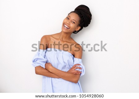 Portrait of stylish young black woman laughing against white background
