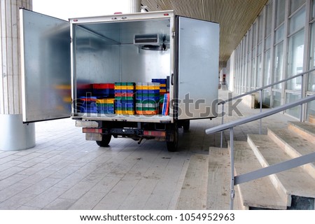The truck delivers boxes with products, unloading