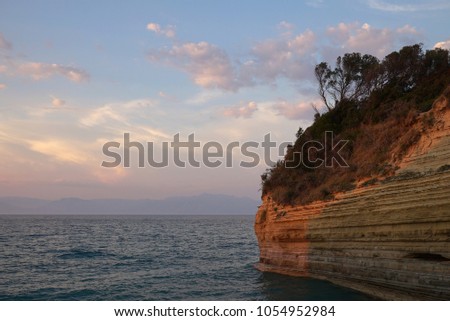 Cliff over the sea at sunset in the evening Greece Corfu Sidari canal of Love the mountain of Albania Ionian sea