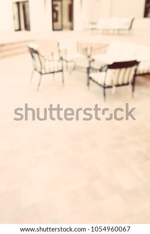 Abstract defocused and blur outdoor dining tables and chairs in hotel resort for background - Vintage colors