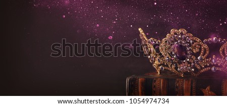 low key image of beautiful queen/king crown over wooden table. vintage filtered. fantasy medieval period Royalty-Free Stock Photo #1054974734