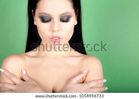 beautiful young girl with closed eyes, showing her professional make up , and perfect skin