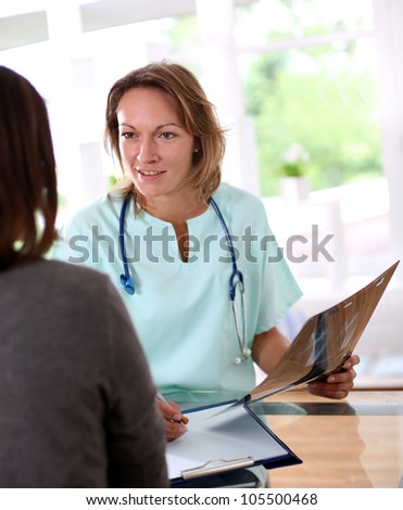 Nurse with patient in check-up room