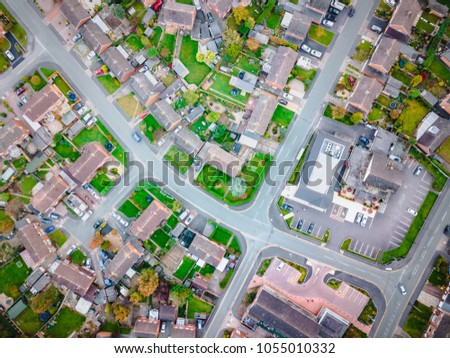 Satellite image style aerial view of homes on an English housing estate. Looking straight down on streets and houses with community and social concepts