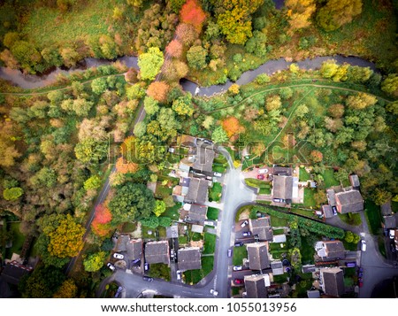 Satellite image style aerial view of country homes rural England. Looking straight down on trees and houses with social and environmental concepts
