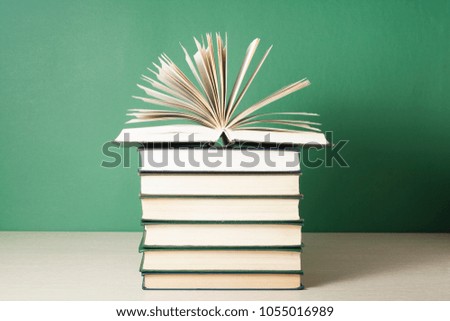 Open book on stack of books on wooden table. Education background. Back to school. Free copy space.