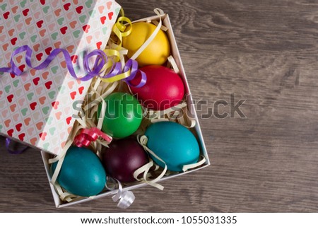 Easter eggs in box on the wooden table