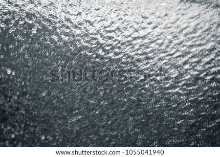 Wet metal surface wallpaper. Flat textured surface. Texture of water in the rain, silver abstract background.