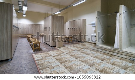 Public shower interior with everal showers, toilet sink and lockers in locker room in luxury fitness spa centre Royalty-Free Stock Photo #1055063822