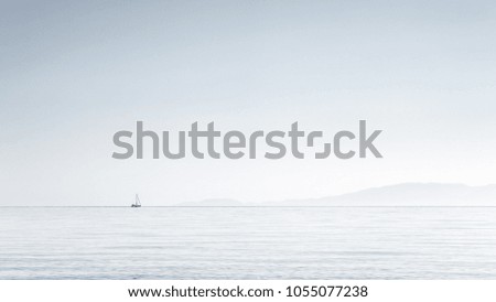 Minimalism, picture of small boat at the horizon,clear sky on Aegean sea, Halkidiki, Greece.