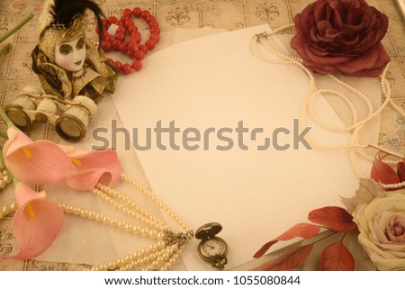Beauty and fashion objects framing a piece of white paper in warm vintage style