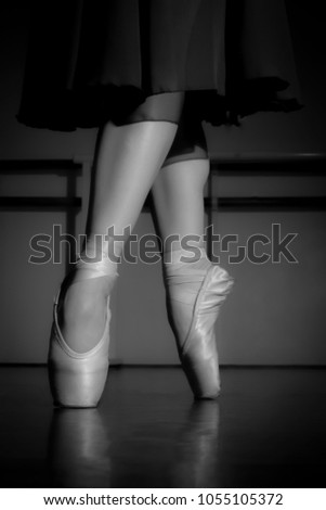 Standing tiptoe dancer. Black and white photography.