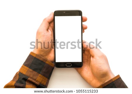 Hand holding black smartphone with blank screen isolated on Closeup photo businessman holding hand credit card and using smartphone. Online payments plastic card. Horizontal mockup. Blurred