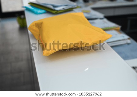 Closeup on letter craft envelope on the office background. Receiving and sending commercial or personal package, top side view communication conceptual design
