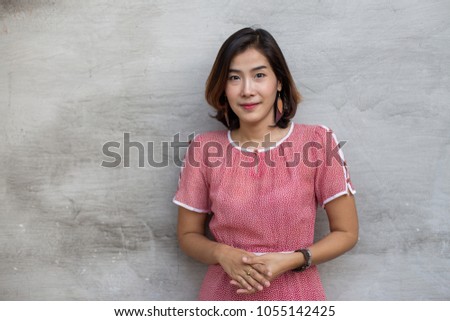 The cute Asia woman is thinking something on gray background