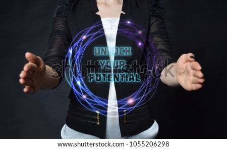 In the hands of a businessman, a neon circle with the inscription:UNLOCK YOUR POTENTIAL