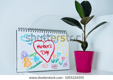 child print. congratulation with happy mother day. plant in pot near child picture
