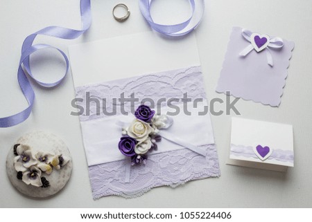 Workspace. Wedding invitation cards, ultraviolet envelopes, ribbons, pussy willow on white background. Overhead view. Flat lay, top view invitation card. copy space. mockup