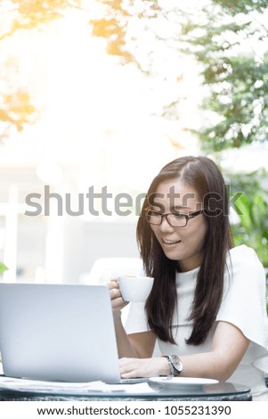 Beautiful asian attractive woman has holding and drinking a coffee before start working at coffee cafe in the morning with happy and relaxing time.