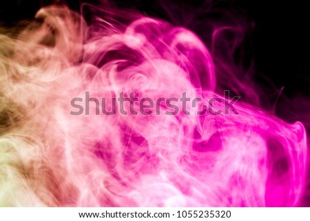 Thick colorful smoke of pink and red  on a black isolated background. Background from the smoke of vape