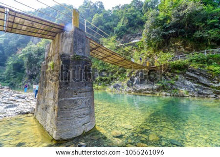 Suspension bridge, Crossing the river, ferriage in the woods Royalty-Free Stock Photo #1055261096