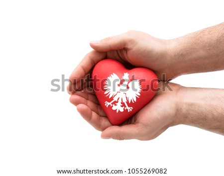 Hands covering Polish coat of arms on a red heart isolated on white background. Clipping path included. 