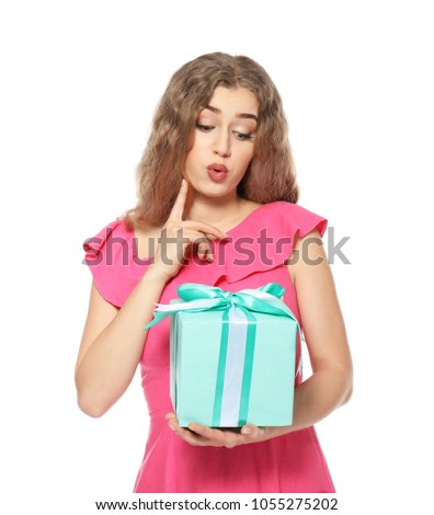 Thoughtful young woman with gift box on white background