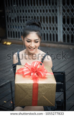A woman receives a gift from his friend.
