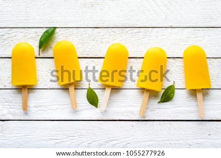 Refreshing popsicles with orange juice, natural ice lollies, flat lay, top view