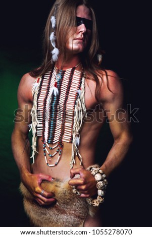 young man in Indian breastplate and black make-up