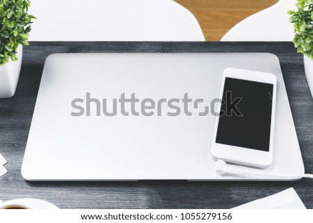 Top view of wooden desktop with laptop smartphone and plants. Mock up 