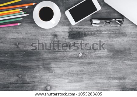 Mix of office supplies, laptop and smartphone on contemporary wooden workplace with other items. Above view. Mock up 