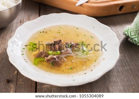 Beef soup on wooden background