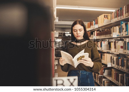 Smiling female student working in a library