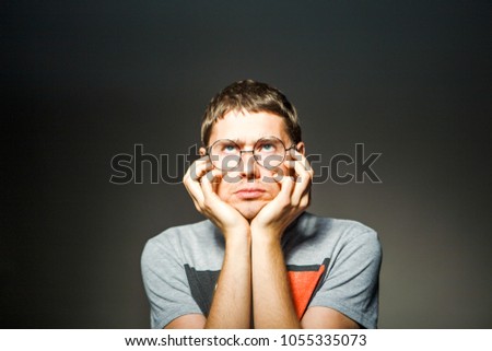 Photo of man in glasses with hands at chin