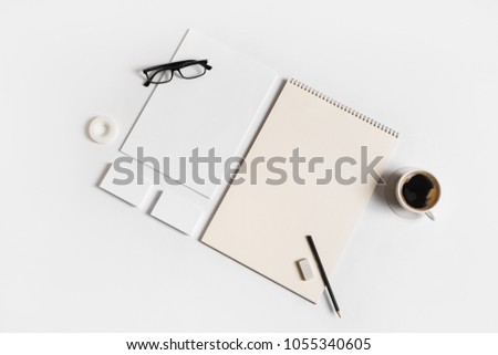 Photo of blank stationery set on white paper background. Corporate identity mock up for placing your design. Top view. Flat lay.