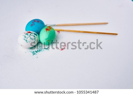 Easter, three eggs, brushes, green, blue, white, paints                       