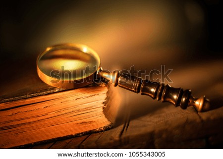 magnifying glass with old book
