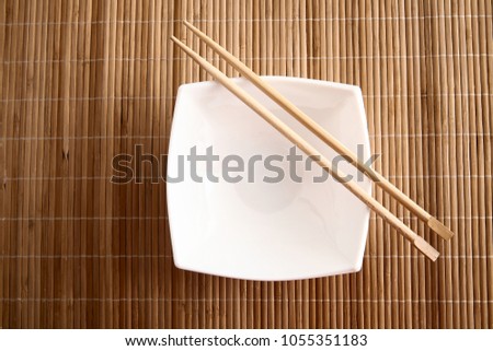 rectangular square white empty plate on a bamboo table stand
