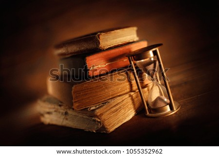 old books with hourglass