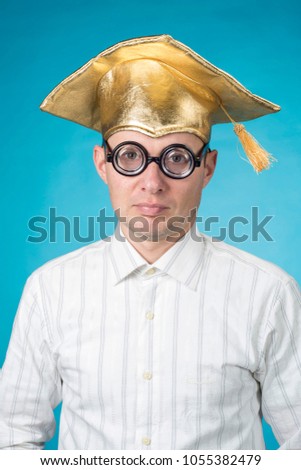 portrait merry young man in the yellow hat of student and glasses