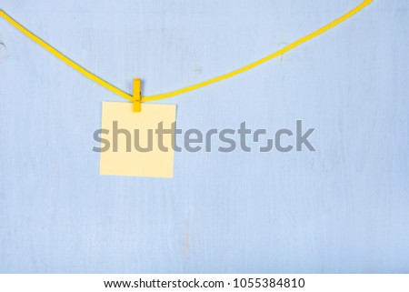 Paper hang on a rope on a blue wooden background.