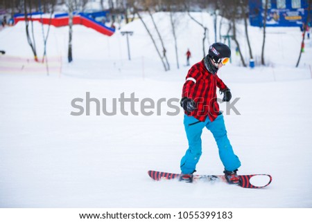 Picture of athlete with snowboard riding in snowy resort
