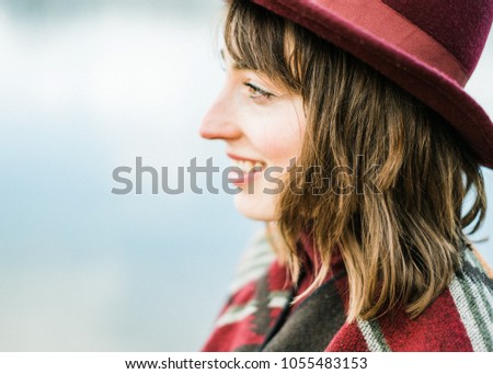 Portrait picture of a young woman enjoying her freedom. Solo traveling or enjoying nature nearby.